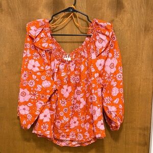 371. Free People Pink Floral Blouse on Orange Background